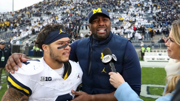 Nov 11, 2023; University Park, Pennsylvania, USA; Michigan Wolverines offensive line coach Sherrone Moore reacts while being interviewed with running back Blake Corum (2) following a game against the Penn State Nittany Lions at Beaver Stadium. Michigan won 24-15. Mandatory Credit: Matthew O'Haren-USA TODAY Sports  